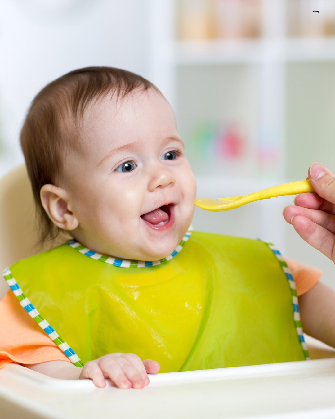 Happy baby being spoon fed — Starting Solids class